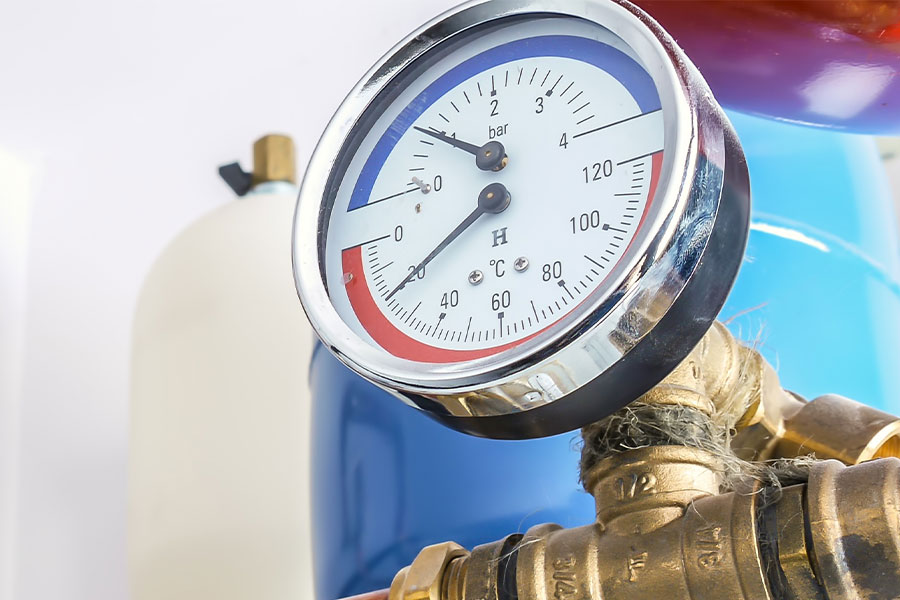 A pressure gauge on plumbing.